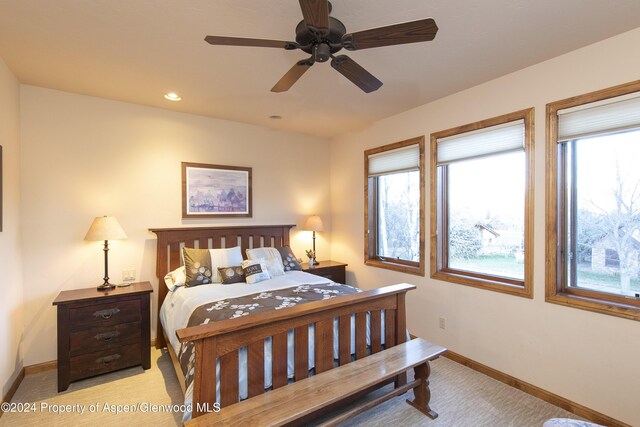 carpeted bedroom featuring ceiling fan