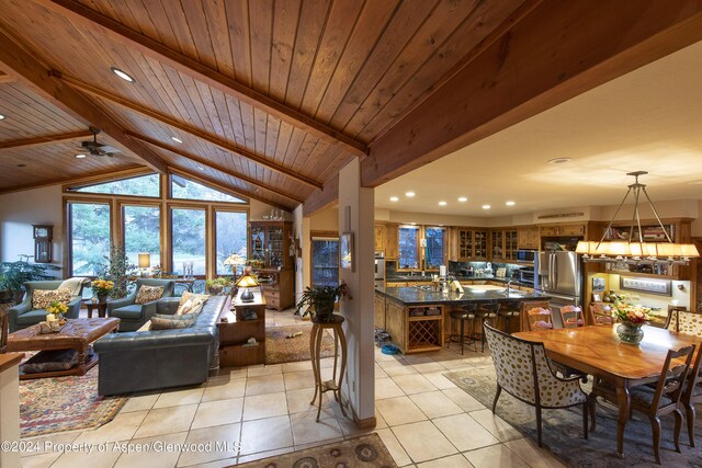 living room featuring wooden ceiling, high vaulted ceiling, ceiling fan, light tile patterned floors, and beamed ceiling