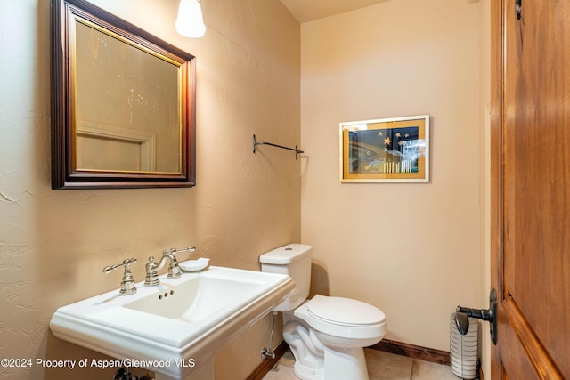 bathroom featuring tile patterned floors, toilet, and sink