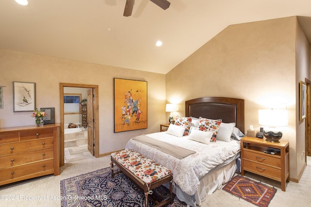 bedroom featuring ensuite bathroom, ceiling fan, light colored carpet, and vaulted ceiling