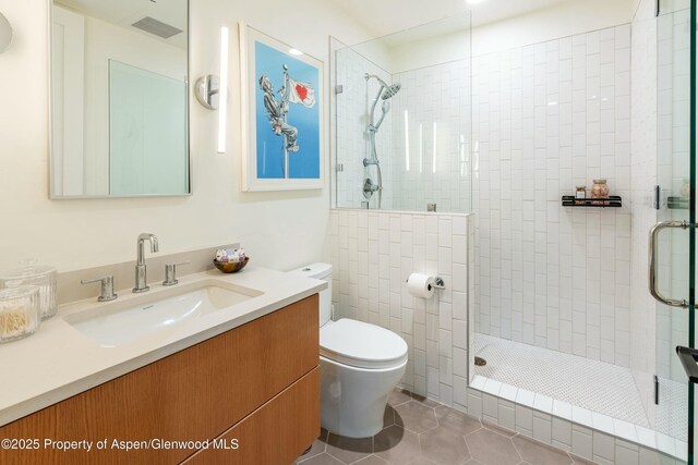 22860 Two Rivers Rd # 270, Basalt, CO 81621 - bathroom featuring tiled shower, vanity, and tile patterned floors