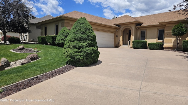 93 Ridge View Pl, Parachute, CO 81635 - view of front of property featuring driveway, stucco siding, an attached garage, and a front yard