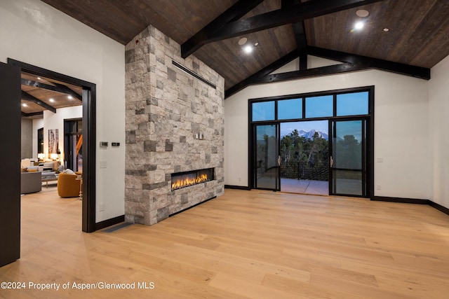 living room with a fireplace, light hardwood / wood-style floors, high vaulted ceiling, and beamed ceiling