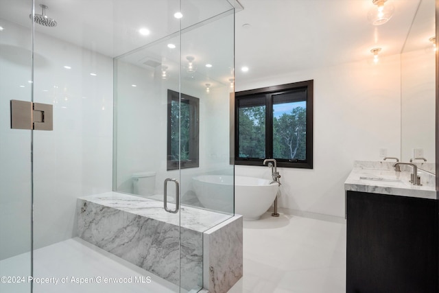 full bathroom featuring vanity, toilet, and independent shower and bath