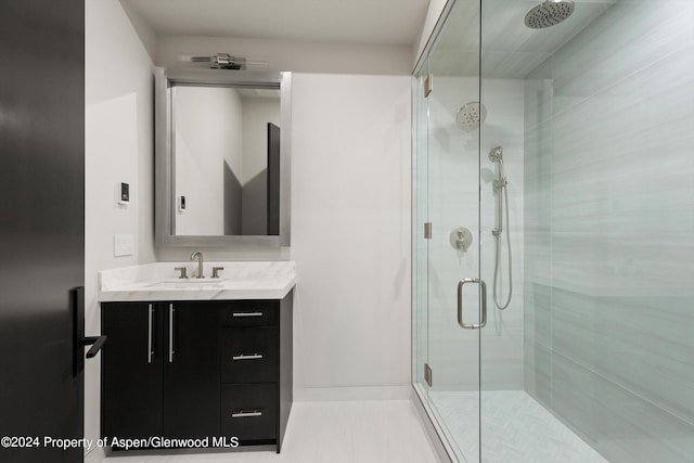 bathroom with vanity and a shower with shower door