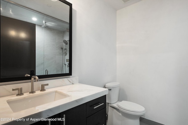 bathroom with vanity, toilet, and a shower with shower door