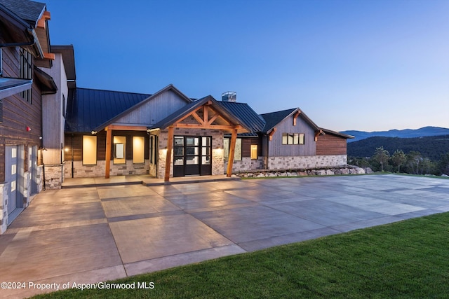 view of front facade featuring a mountain view and french doors