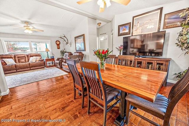 dining room featuring ceiling fan, hardwood / wood-style floors, and lofted ceiling