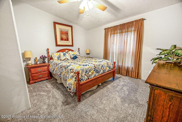 carpeted bedroom featuring lofted ceiling, a textured ceiling, and ceiling fan