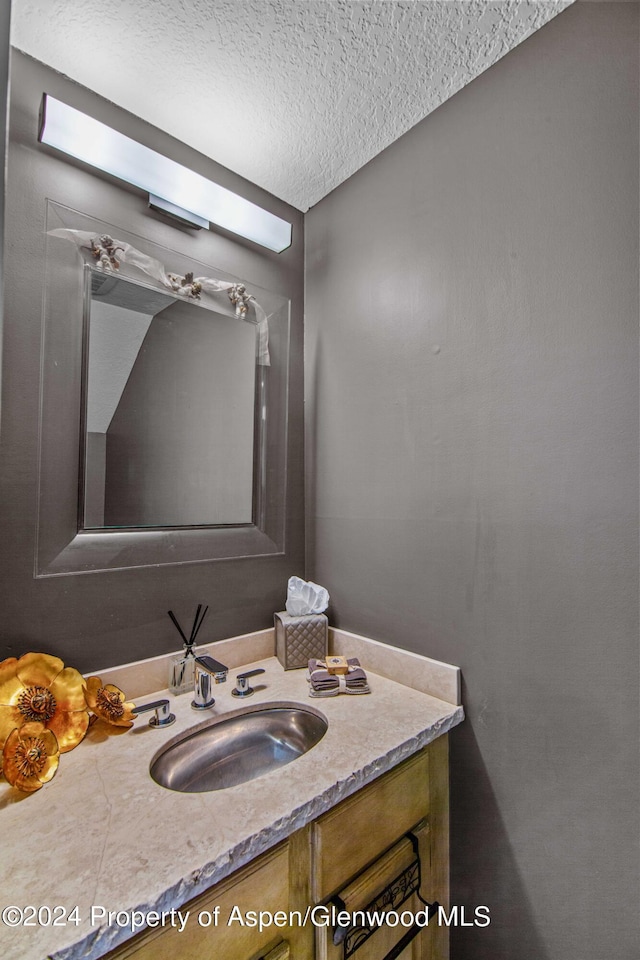 bathroom featuring vanity and a textured ceiling