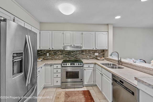 kitchen featuring backsplash, white cabinets, sink, a textured ceiling, and stainless steel appliances