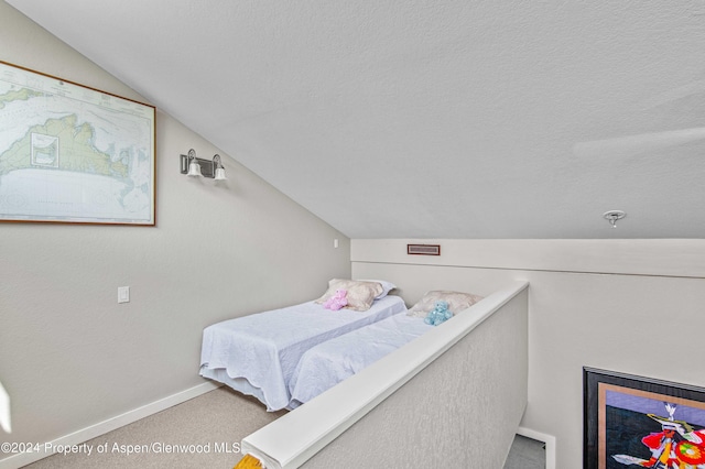 bedroom with carpet flooring, a textured ceiling, and vaulted ceiling