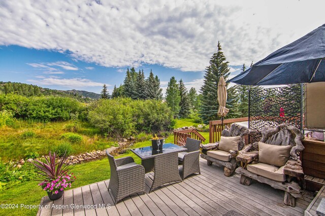 115 Harleston Grn Unit 63, Snowmass Village, CO 81615 - deck featuring outdoor dining area and a mountain view