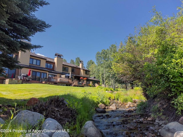 115 Harleston Grn Unit 63, Snowmass Village, CO 81615 - view of green lawn featuring a deck