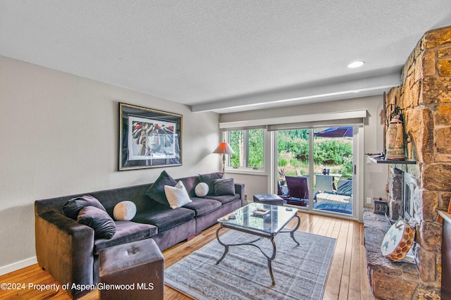 115 Harleston Grn Unit 63, Snowmass Village, CO 81615 - living area featuring a textured ceiling and hardwood / wood-style floors