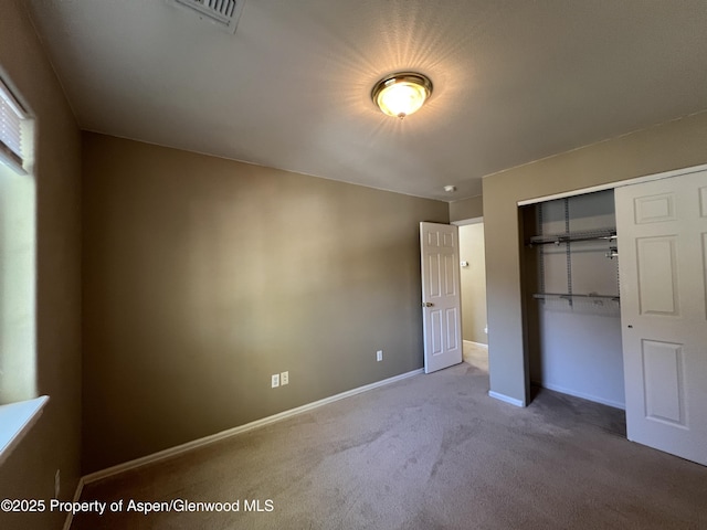 unfurnished bedroom with a closet and carpet