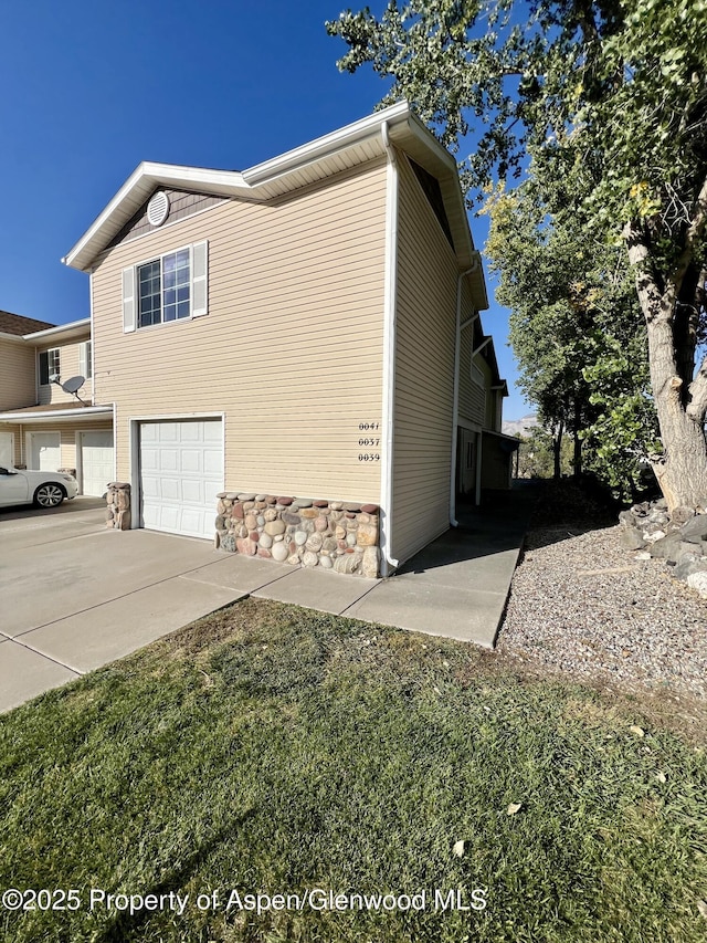 view of side of home featuring a garage