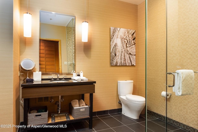 bathroom featuring sink, tile patterned floors, and toilet