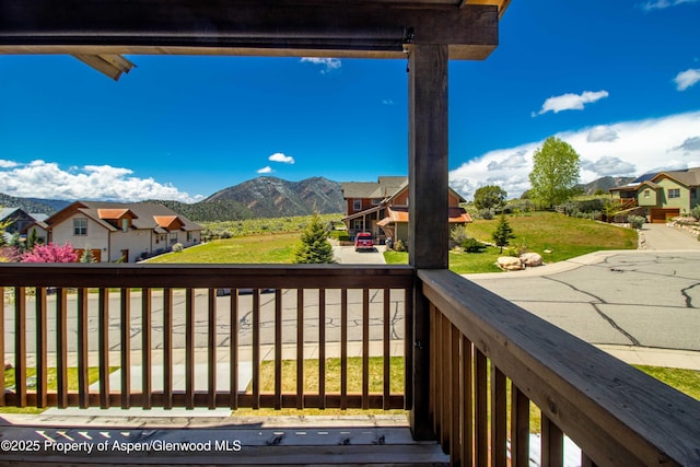 deck with a mountain view and a residential view