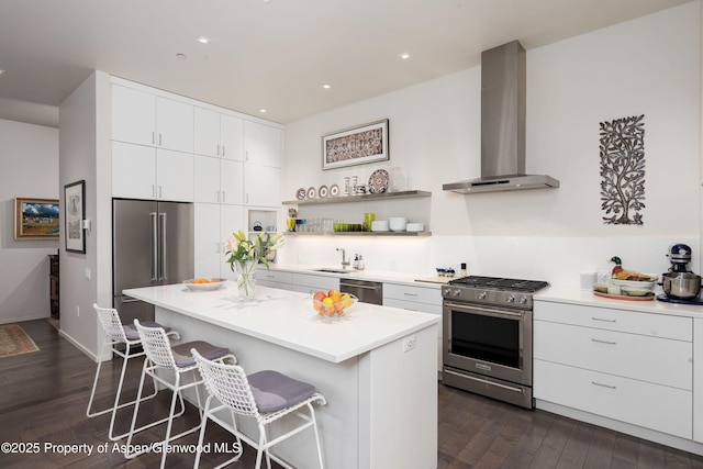 102 Evans Rd Unit 104, Basalt, CO 81621 - kitchen with premium appliances, wall chimney exhaust hood, a kitchen breakfast bar, dark wood finished floors, and a center island