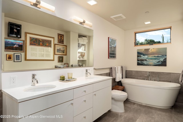 102 Evans Rd Unit 104, Basalt, CO 81621 - bathroom with double vanity, a freestanding bath, tile walls, tile patterned flooring, and a wainscoted wall