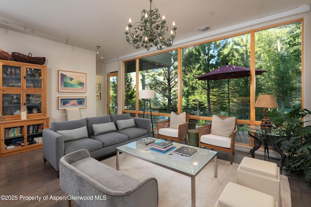 102 Evans Rd Unit 104, Basalt, CO 81621 - living area with expansive windows, wood finished floors, a chandelier, and track lighting