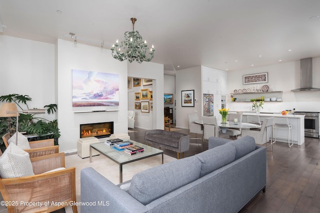 102 Evans Rd Unit 104, Basalt, CO 81621 - living area featuring a chandelier, dark wood finished floors, a glass covered fireplace, and recessed lighting