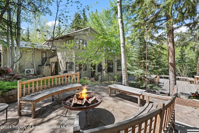 view of patio / terrace with an outdoor fire pit and a wooden deck