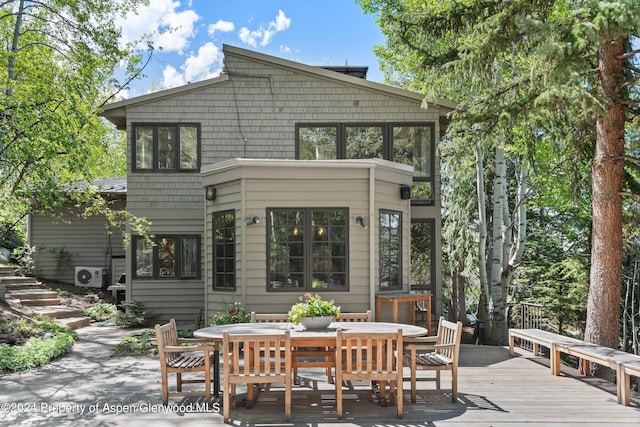 rear view of property featuring a deck