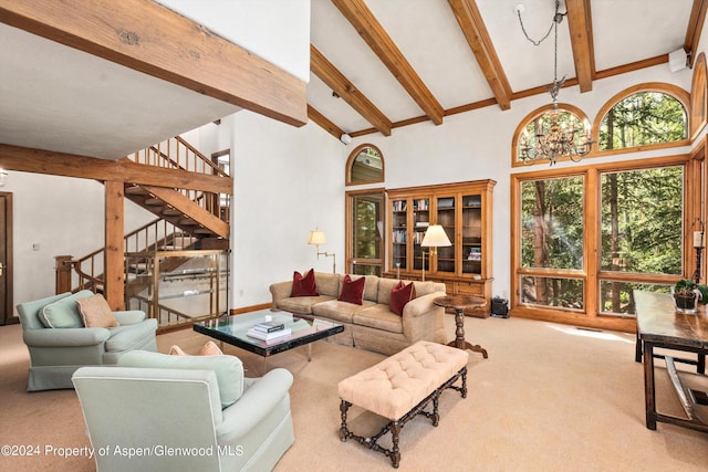 carpeted living room featuring beam ceiling, high vaulted ceiling, and an inviting chandelier