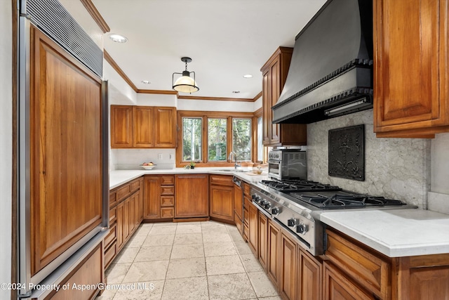 kitchen featuring backsplash, sink, decorative light fixtures, paneled built in fridge, and range hood