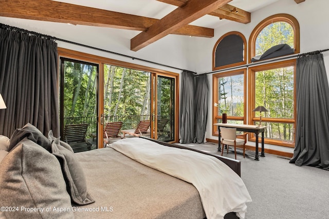 carpeted bedroom featuring beamed ceiling and access to outside