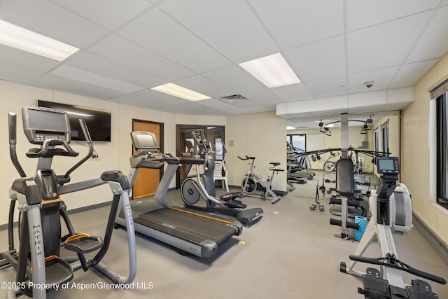 exercise room with a paneled ceiling