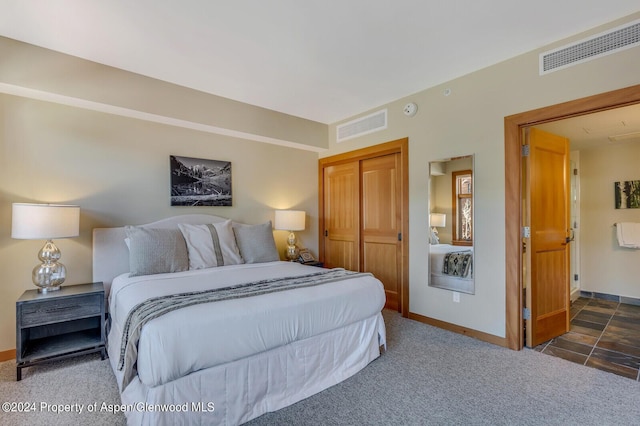 carpeted bedroom with a closet