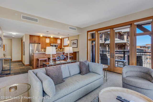 living room with french doors and dark carpet