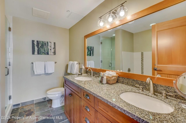 bathroom with vanity, toilet, and a shower with shower door