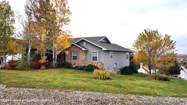 view of side of home with a yard