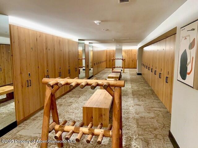 interior space with wooden walls and visible vents