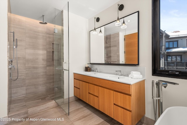 bathroom featuring a sink, a soaking tub, double vanity, and a shower stall