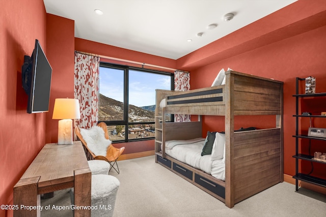 carpeted bedroom with recessed lighting and a mountain view