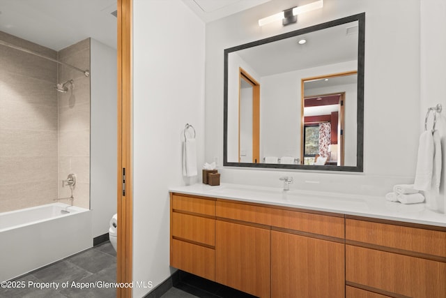 bathroom featuring tile patterned flooring, toilet, vanity, and bathtub / shower combination