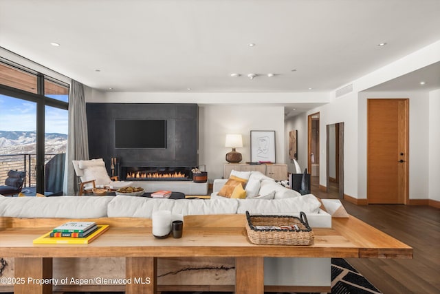 bedroom featuring visible vents, wood finished floors, recessed lighting, a fireplace, and baseboards