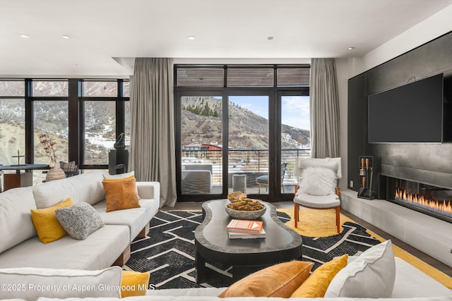 living area featuring a large fireplace and expansive windows