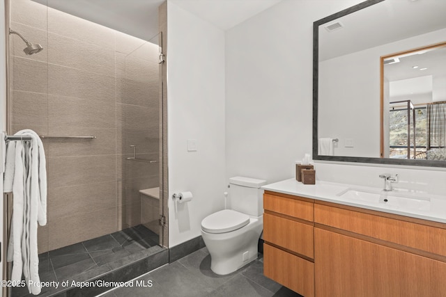 full bathroom featuring tile patterned flooring, visible vents, toilet, tiled shower, and vanity