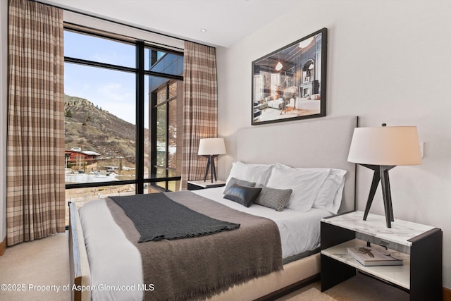 bedroom with a mountain view and carpet