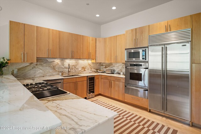 250 Mountain Laurel Dr Unit B, Aspen, CO 81611 - kitchen with built in appliances, wine cooler, a warming drawer, a sink, and light stone countertops
