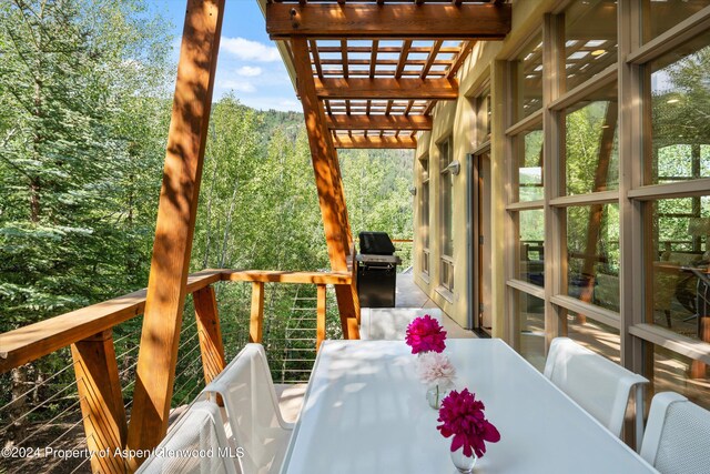 250 Mountain Laurel Dr Unit B, Aspen, CO 81611 - wooden deck with outdoor dining space, a grill, and a pergola