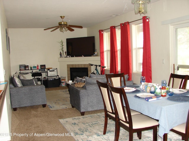 2701 Midland Ave Unit 0511, Glenwood Springs, CO 81601 - dining room featuring a tiled fireplace, a ceiling fan, and carpet floors