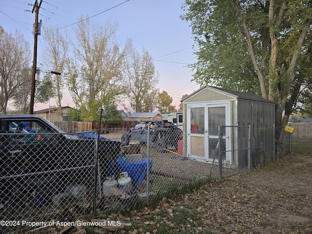 yard at dusk with an outbuilding