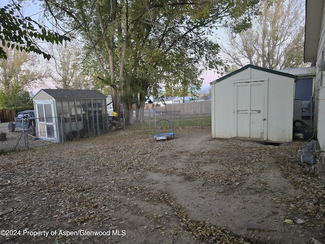 yard at dusk with an outbuilding